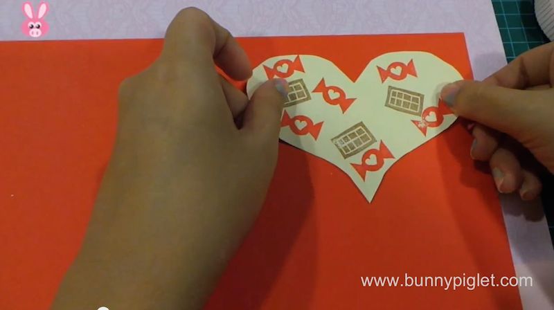 stick heart on red paper 